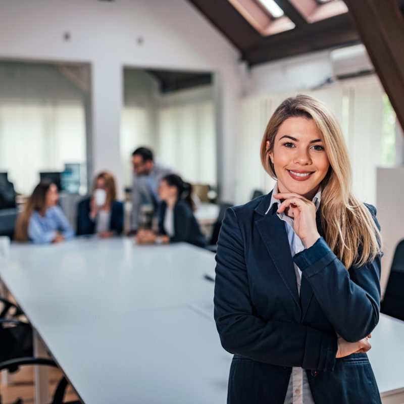 Portrait,Of,A,Business,Woman,With,A,Team,In,Meeting